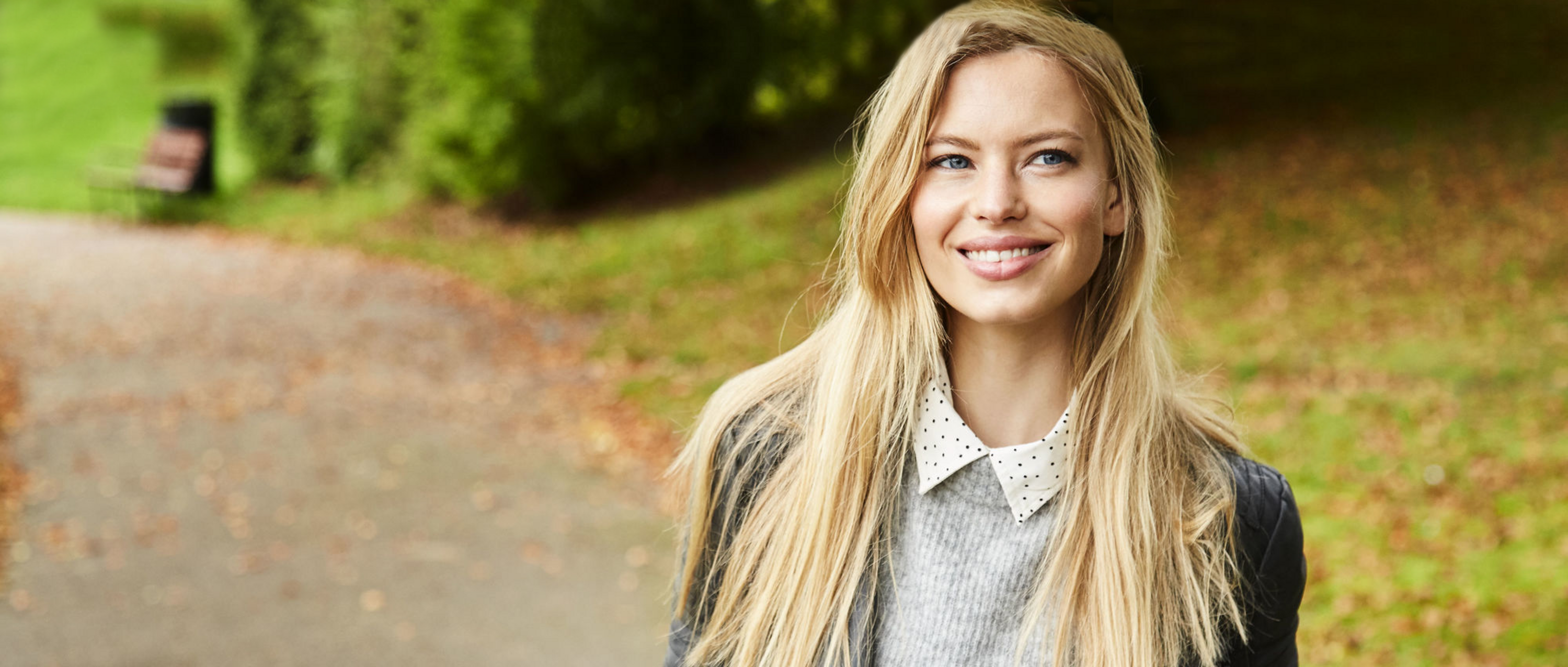 Junge Frau geht im Wald spazieren.